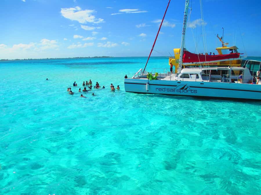 Cartagena: Party Boat to Cholon Beach with 2 Drinks & Lunch - Timing, guides, and language