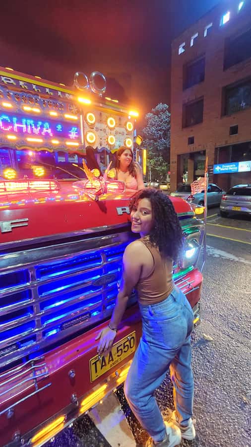 Medellin: Party Bus with DJ & Street Food Tastings - The 4 Sur Bridge under colored lights